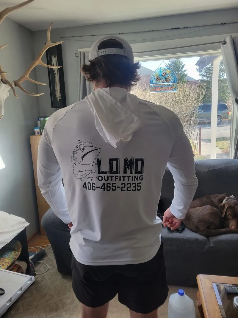 Men's white sun hoodie with Lo Mo Outfitting logo on back, worn by model