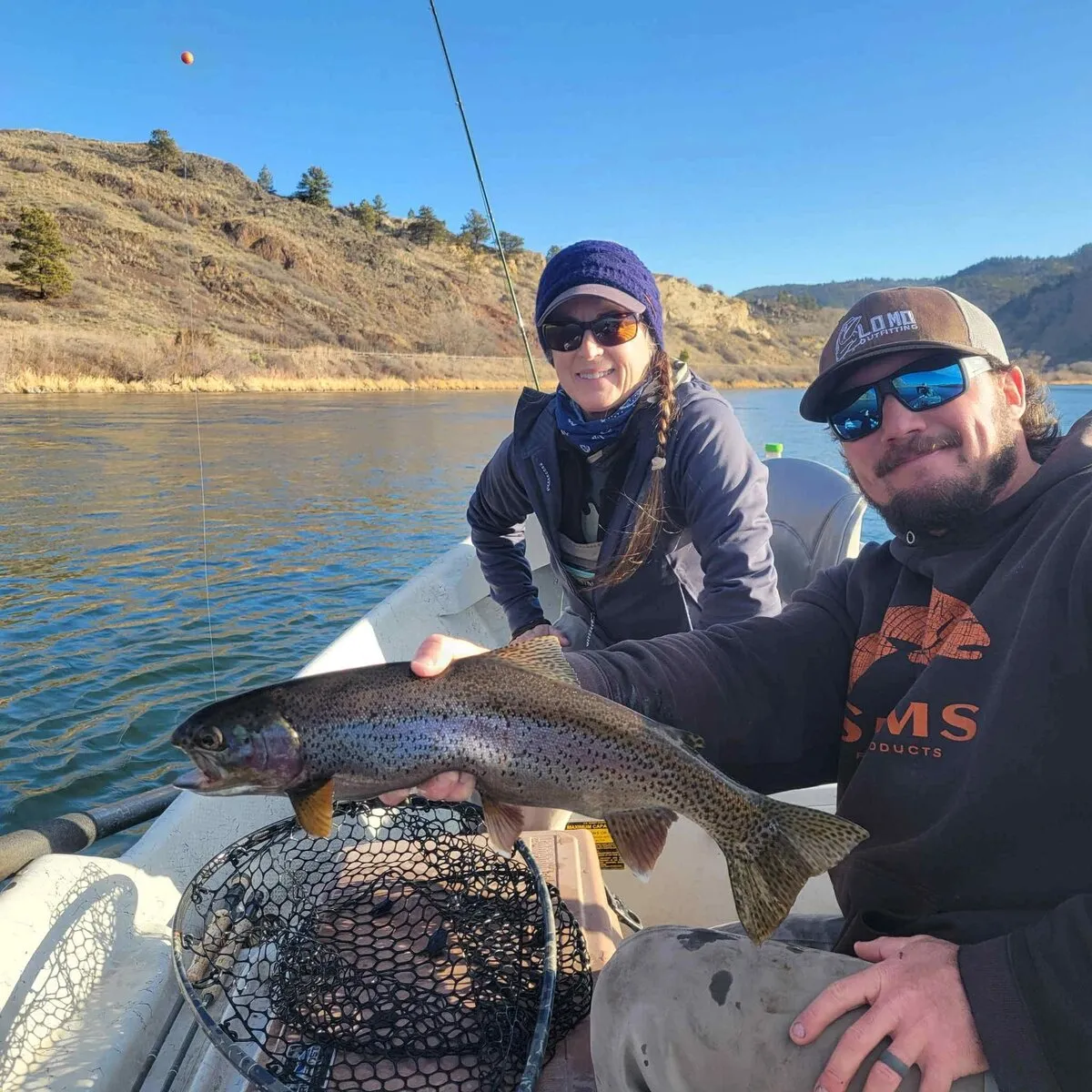 Anglers with a rainbow trout on the Missouri River